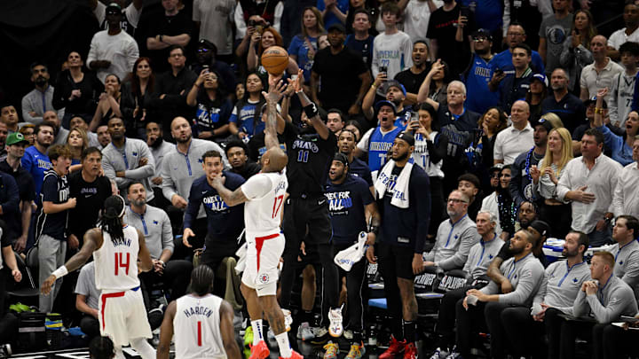 May 3, 2024; Dallas, Texas, USA; Dallas Mavericks guard Kyrie Irving (11) makes a three point shot and is fouled by LA Clippers forward P.J. Tucker (17) during the fourth quarter during game six of the first round for the 2024 NBA playoffs at American Airlines Center. Mandatory Credit: Jerome Miron-Imagn Images