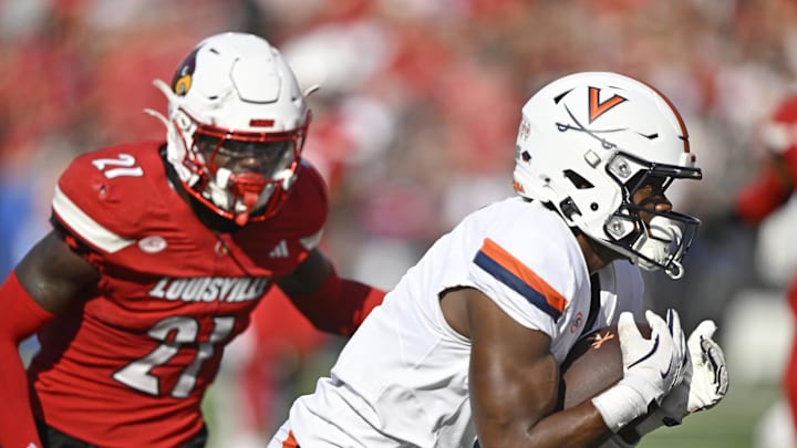 Oct 4, 2025; Louisville, Kentucky, USA; Virginia Cavaliers wide receiver Cam Ross (6) catches a pass against Louisville Cardinals defensive back D'Angelo Hutchinson (21) during the second quarter at L&N Federal Credit Union Stadium. Mandatory Credit: Jamie Rhodes-Imagn Images
