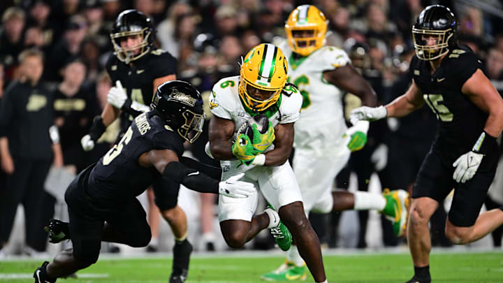 Oct 18, 2024; West Lafayette, Indiana, USA; Oregon Ducks running back Noah Whittington (6) is tackled by Purdue Boilermakers defensive back Smiley Bradford (6) during the first quarter at Ross-Ade Stadium. Mandatory Credit: Marc Lebryk-Imagn Images