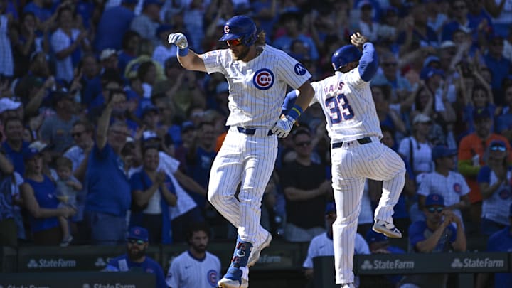 Sep 21, 2024; Chicago, Illinois, USA;  Chicago Cubs first baseman Patrick Wisdom (16) celebrates with third base coach Willie Harris (33) after he hit a home run against the Washington Nationals during the seventh inning at Wrigley Field. Mandatory Credit: Matt Marton-Imagn Images