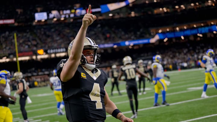 Dec 1, 2024; New Orleans, Louisiana, USA; New Orleans Saints quarterback Derek Carr (4) reacts after rushing for a first down against the Los Angeles Rams during the fourth quarter at Caesars Superdome.  