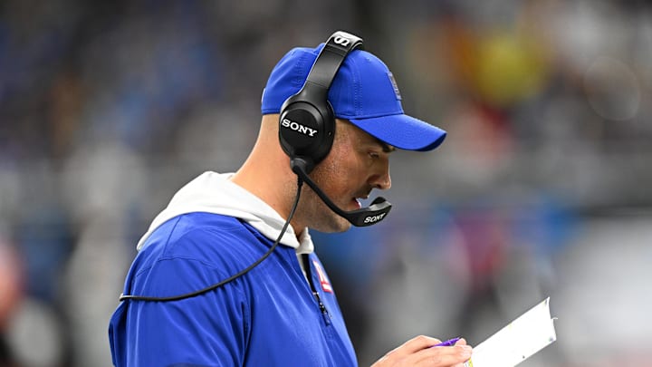 Nov 23, 2025; Detroit, Michigan, USA; New York Giants interim head coach Mike Kafka reviews the play sheet during the third quarter against the Detroit Lions at  Ford Field.  