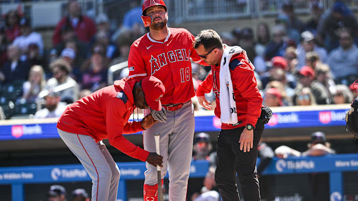 Apr 26, 2025; Minneapolis, Minnesota, USA; Los Angeles Angels first base Nolan Schanuel (18) is assisted by manager Ron Washington (left) and a team trainer after suffering a knee injury during the fourth inning against the Minnesota Twins at Target Field. Mandatory Credit: Jeffrey Becker-Imagn Images
