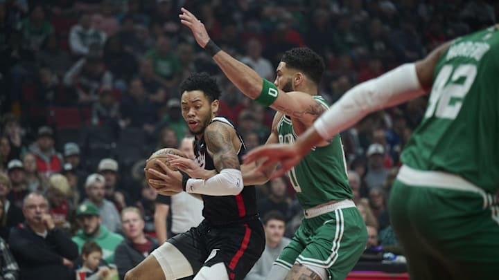 Mar 23, 2025; Portland, Oregon, USA: Portland Trail Blazers guard Anfernee Simons (1) dribbles the ball during the first half against Boston Celtics forward Jayson Tatum (0) at Moda Center. Mandatory Credit: Troy Wayrynen-Imagn Images