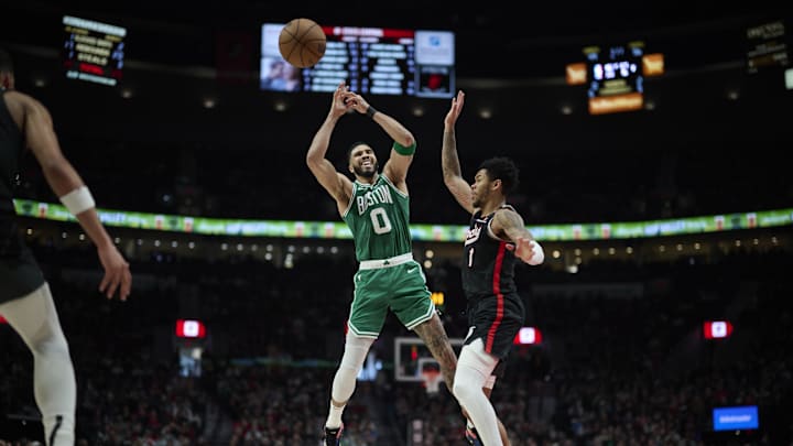 Mar 23, 2025; Portland, Oregon, USA; Boston Celtics forward Jayson Tatum (0) is fouled by Portland Trail Blazers guard Anfernee Simons (1) during the first half at Moda Center. Mandatory Credit: Troy Wayrynen-Imagn Images