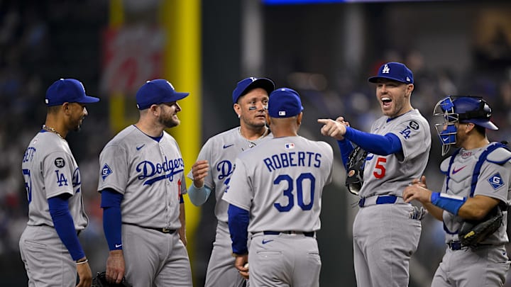 Dodgers shortstop Mookie Betts (50) and third baseman Max Muncy (13) and second baseman Miguel Rojas (72) and manager Dave Roberts (30) and first baseman Freddie Freeman (5) and catcher Austin Barnes (15) during the game between the Texas Rangers and the Los Angeles Dodgers at Globe Life Field. 