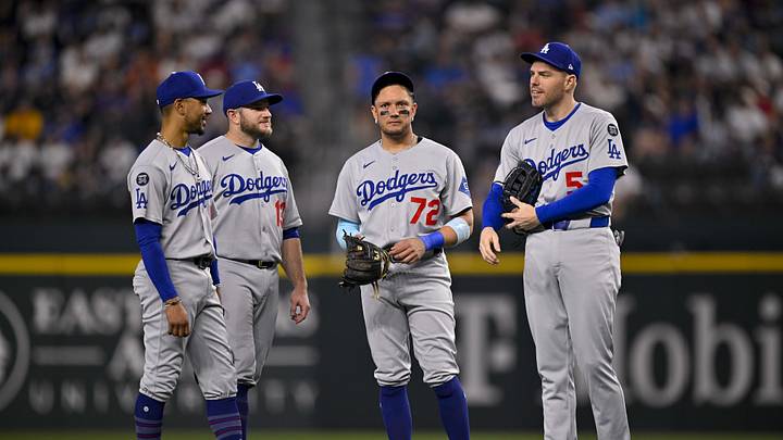 Apr 20, 2025; Arlington, Texas, USA; Los Angeles Dodgers shortstop Mookie Betts (50) and second baseman Miguel Rojas (72) and first baseman Freddie Freeman (5) and third baseman Max Muncy (13) during the game between the Texas Rangers and the Los Angeles Dodgers at Globe Life Field. Mandatory Credit: Jerome Miron-Imagn Images