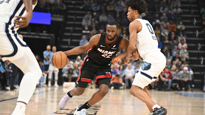 Mar 15, 2025; Memphis, Tennessee, USA; Miami Heat small forward Andrew Wiggins (22) drives into Memphis Grizzlies forward Jalen Wells (0) in the first quarter of the game against the Memphis Grizzlies at FedExForum. Mandatory Credit: Matthew Smith-Imagn Images