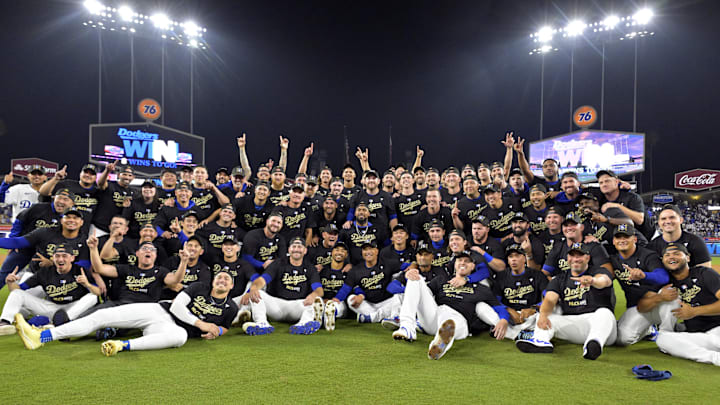Oct 11, 2024; Los Angeles, California, USA; Los Angeles Dodgers players and coaches celebrate on the field after defeating the San Diego Padres in game five of the NLDS for the 2024 MLB Playoffs at Dodger Stadium. Mandatory Credit: Jayne Kamin-Oncea-Imagn Images