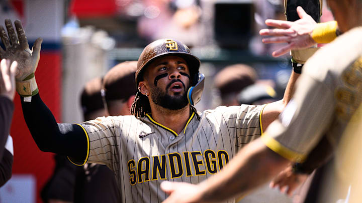 San Diego Padres second baseman Fernando Tatis Jr. (23) is greeted by teammates after scoring during the fourth inning against the Los Angeles Angels at Angel Stadium on April 19, 2026.