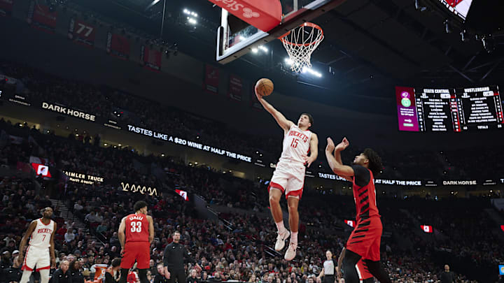 Jan 9, 2026; Portland, Oregon, USA; Houston Rockets guard Reed Sheppard (15) scores a basket during the first half against Portland Trail Blazers guard Shaedon Sharpe (17) at Moda Center. Mandatory Credit: Troy Wayrynen-Imagn Images