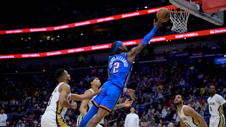 Dec 7, 2024; New Orleans, Louisiana, USA; Oklahoma City Thunder guard Shai Gilgeous-Alexander (2) shoots against New Orleans Pelicans guard CJ McCollum (3) during the first half at Smoothie King Center. Mandatory Credit: Matthew Hinton-Imagn Images