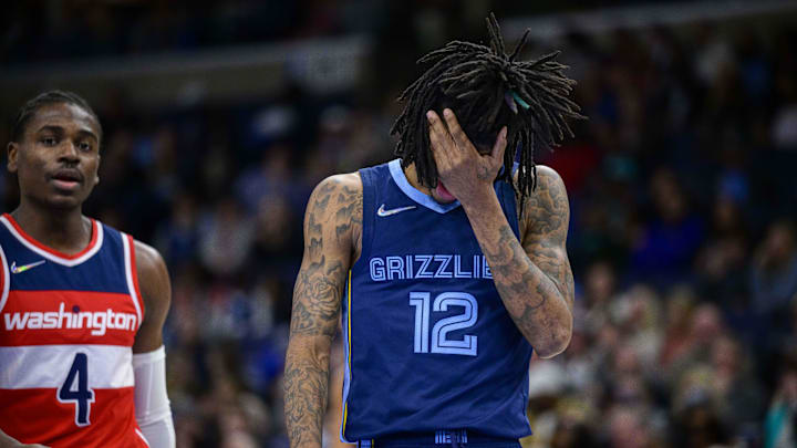 Jan 29, 2022; Memphis, Tennessee, USA; Memphis Grizzlies guard Ja Morant (12) reacts to being hit in the face during the second half against the Washington Wizards at the FedExForum. Mandatory Credit: Jerome Miron-Imagn Images