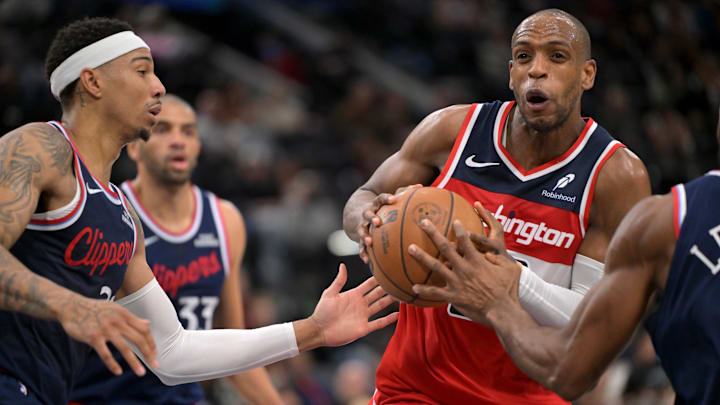 Jan 14, 2026; Inglewood, California, USA; Los Angeles Clippers guard Jordan Miller (22) defends Washington Wizards forward Khris Middleton (22) as he drives to the basket in the second half at Intuit Dome. Mandatory Credit: Jayne Kamin-Oncea-Imagn Images