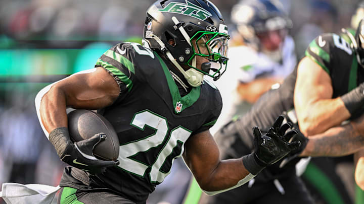 Dec 1, 2024; East Rutherford, New Jersey, USA; New York Jets running back Breece Hall (20) runs with the ball during the first quarter against the Seattle Seahawks at MetLife Stadium. 
