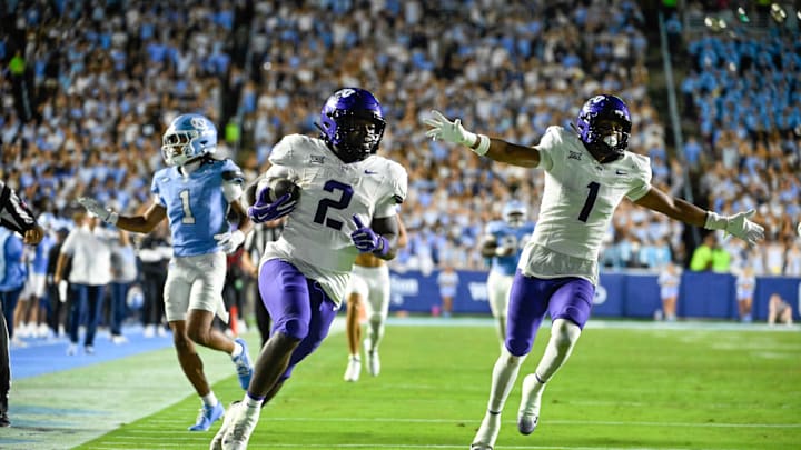 Sep 1, 2025; Chapel Hill, North Carolina, USA; TCU Horned Frogs running back Kevorian Barnes (2) scores a touchdown as safety Austin Jordan (1) celebrates and North Carolina Tar Heels defensive back Thaddeus Dixon (1) defends in the third quarter at Kenan Stadium. Mandatory Credit: Bob Donnan-Imagn Images