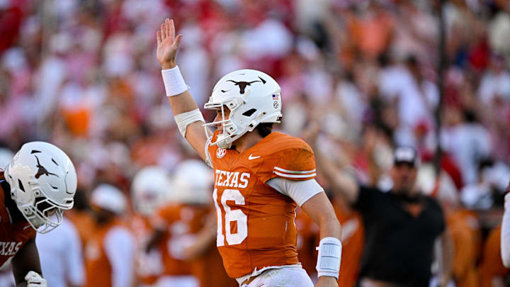 Oct 11, 2025; Dallas, Texas, USA; Texas Longhorns quarterback Arch Manning (16) waves to the Oklahoma Sooners fans after he runs for a first down during the second half at the Cotton Bowl. Mandatory Credit: Jerome Miron-Imagn Images