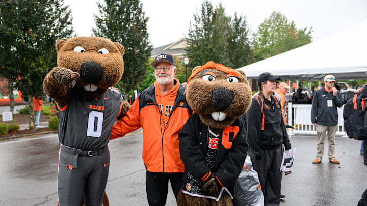 Oct 11, 2025; Corvallis, Oregon, USA; Oregon State Beavers fan poses with the mascots Benny and Bernice outside Reser Stadium before the game against the Wake Forest Demon Deacons. Mandatory Credit: Craig Strobeck-Imagn Images Oct 11, 2025; Corvallis, Oregon, USA; Oregon State Beavers fan poses with the mascots Benny and Bernice outside Reser Stadium before the game against the Wake Forest Demon Deacons. Mandatory Credit: Craig Strobeck-Imagn Images