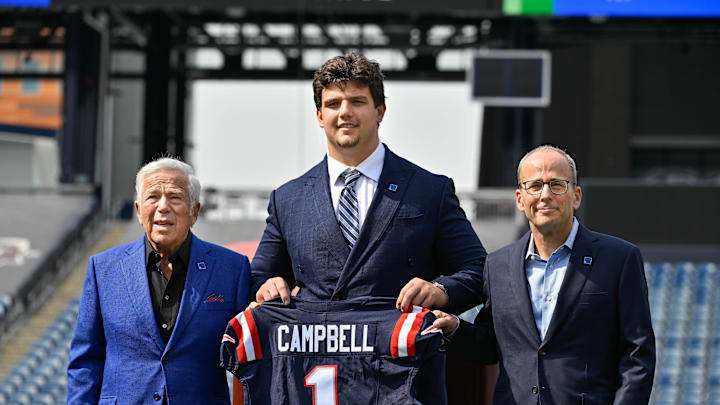 Apr 25, 2025; Foxborough, MA, USA; New England Patriots first round draft pick Will Campbell is presented with a ceremonial first round jersey by team owner Robert Kraft (l) and team president Jonathan Kraft (r) at a press conference on the game field at Gillette Stadium.  Mandatory Credit: Eric Canha-Imagn Images
