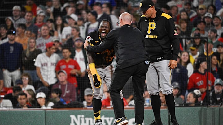 Aug 29, 2025; Boston, Massachusetts, USA; Pittsburgh Pirates second baseman Ronny Simon (63) is checked by medical staff after sliding into home plate against the Boston Red Sox during the eighth inning at Fenway Park. Mandatory Credit: Eric Canha-Imagn Images