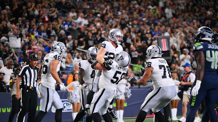 Aug 7, 2025; Seattle, Washington, USA; Las Vegas Raiders center Jackson Powers-Johnson (58) celebrates with running back Dylan Laube (23) after Laube scored a touchdown against the Seattle Seahawks during the second half at Lumen Field. Mandatory Credit: Steven Bisig-Imagn Images