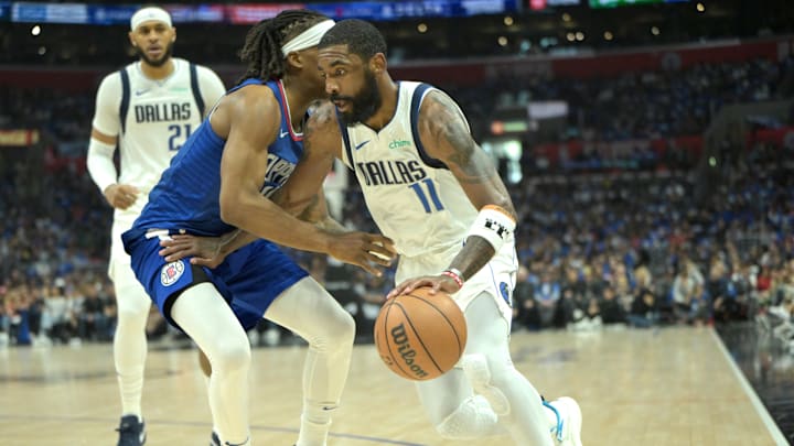  Apr 21, 2024; Los Angeles, California, USA; Dallas Mavericks guard Kyrie Irving (11) is defended by
