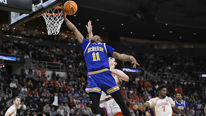 Mar 20, 2025; Providence, RI, USA; McNeese State Cowboys guard Quadir Copeland (11) drives to the basket for a layup over Clemson Tigers forward Ian Schieffelin (4) during the second half at Amica Mutual Pavilion. Mandatory Credit: Eric Canha-Imagn Images Mar 20, 2025; Providence, RI, USA; McNeese State Cowboys guard Quadir Copeland (11) drives to the basket for a layup over Clemson Tigers forward Ian Schieffelin (4) during the second half at Amica Mutual Pavilion. Mandatory Credit: Eric Canha-Imagn Images