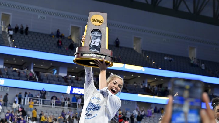 Apr 20, 2024; Fort Worth, TX, USA; LSU Tigers gymnast Olivia Dunne poses with the championship trophy after the LSU Tigers gymnastics team wins the national championship in the 2024 Womens National Gymnastics Championship at Dickies Arena. Mandatory Credit: Jerome Miron-USA TODAY Sports Apr 20, 2024; Fort Worth, TX, USA; LSU Tigers gymnast Olivia Dunne poses with the championship trophy after the LSU Tigers gymnastics team wins the national championship in the 2024 Womens National Gymnastics Championship at Dickies Arena. Mandatory Credit: Jerome Miron-USA TODAY Sports