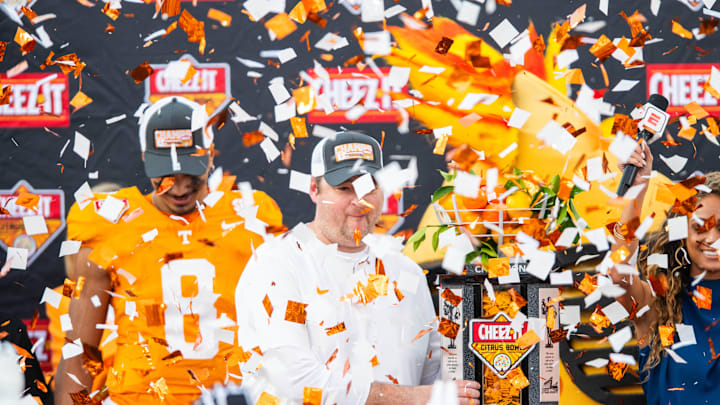 Jan 1, 2024; Orlando, FL, USA; Tennessee Volunteers head coach Josh Huepel receives the trophy after the win against the Iowa Hawkeyes at Camping World Stadium. Mandatory Credit: Jeremy Reper-Imagn Images
