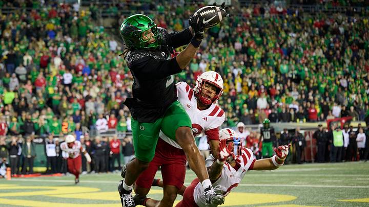 Oct 17, 2026; Eugene, Oregon, USA; Oregon Ducks tight end Jamari Johnson (9) catches a touchdown pass during the second half against Nebraska Cornhuskers defensive back Caleb Benning (28) and defensive back Donovan Jones (8) at Autzen Stadium. Mandatory Credit: Troy Wayrynen-Imagn Images