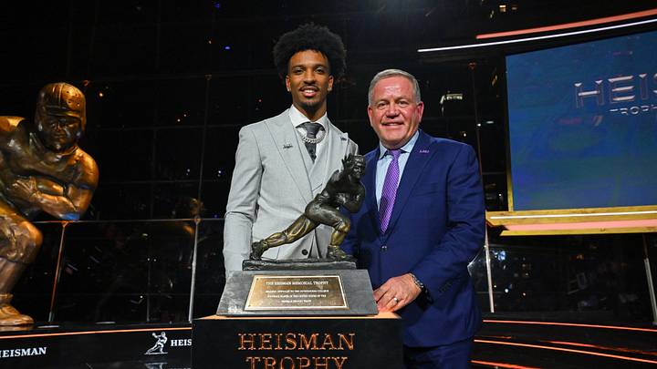 Dec 9, 2023; New York, New York, USA; Jayden Daniels poses with LSU coach Brian Kelly after winning the Heisman Trophy in the Astor ballroom at the New York Marriott Marquis. Mandatory Credit: Todd Van Emst/Heisman Trust/Pool-USA TODAY Sports