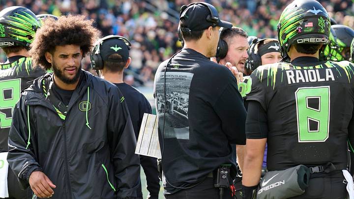 Injured Oregon quarterback Dante Moore, left, walks past quarterback Dylan Raiola during the UCLA game. Injured Oregon quarterback Dante Moore, left, walks past quarterback Dylan Raiola during the UCLA game.