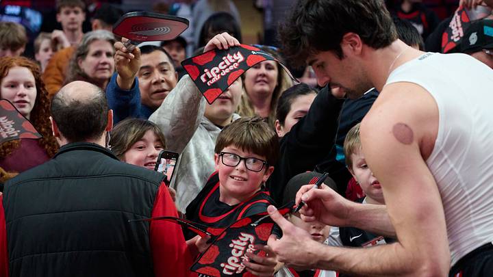 Portland Trail Blazers forward Deni Avdija signs autographs for fans before a game against the Sacramento Kings at the Moda Center. Portland Trail Blazers forward Deni Avdija signs autographs for fans before a game against the Sacramento Kings at the Moda Center.