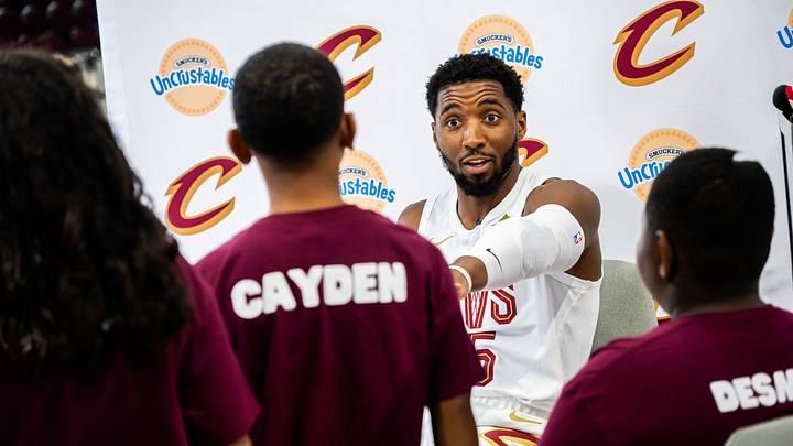 Sep 28, 2026; Cleveland, OH, USA; Cleveland Cavaliers guard Donovan Mitchell (45) talks to the Cavaliers Kids Club during media day at Rocket Arena. Mandatory Credit: Ken Blaze-Imagn Images