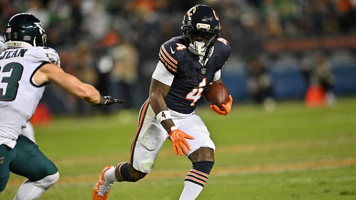 Sep 28, 2026; Chicago, Illinois, USA;  Chicago Bears running back D'Andre Swift (4) runs against Philadelphia Eagles defensive back Cooper DeJean (33) during the first half at Soldier Field.  