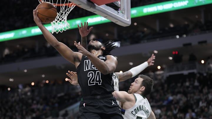Jan 2, 2025; Milwaukee, Wisconsin, USA; Brooklyn Nets guard Cam Thomas (24) puts up a shot against Milwaukee Bucks guard Pat Connaughton (24) in the second half at Fiserv Forum. Mandatory Credit: Michael McLoone-Imagn Images