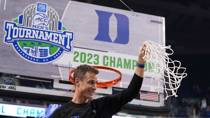 Mar 11, 2023; Greensboro, NC, USA;  Duke Blue Devils head coach Jon Scheyer holds up the net after