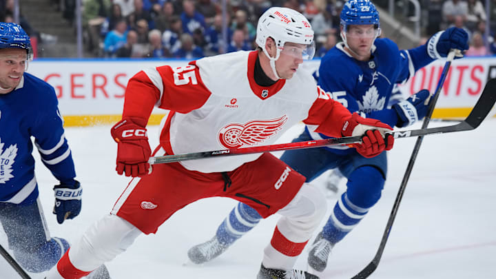 Elmer Soderblom (85) battles multiple members of the Toronto Maple Leafs for the puck. 
