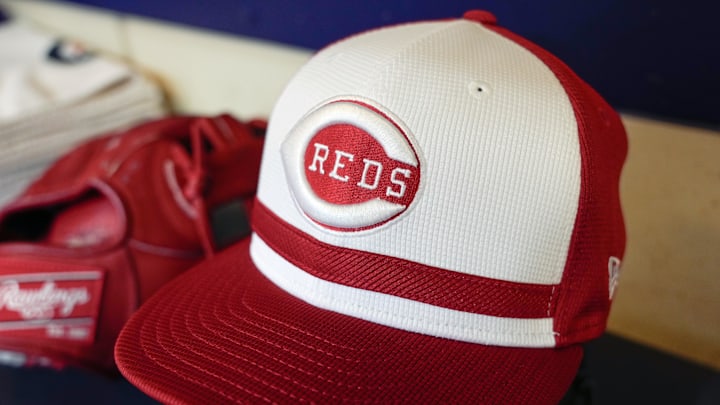 Apr 5, 2025; Milwaukee, Wisconsin, USA;  General view of a Cincinnati Reds cap in the dugout prior to the game against the Milwaukee Brewers at American Family Field. Mandatory Credit: Jeff Hanisch-Imagn Images