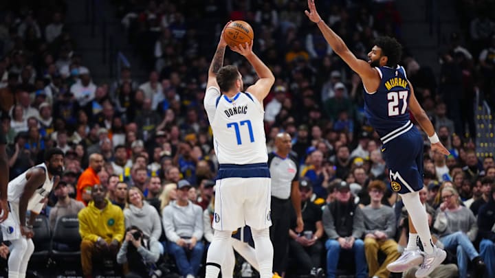 Nov 10, 2024; Denver, Colorado, USA; Dallas Mavericks guard Luka Doncic (77) prepares to shoot the ball at Denver Nuggets guard Jamal Murray (27) in the first quarter at Ball Arena. Mandatory Credit: Ron Chenoy-Imagn Images Nov 10, 2024; Denver, Colorado, USA; Dallas Mavericks guard Luka Doncic (77) prepares to shoot the ball at Denver Nuggets guard Jamal Murray (27) in the first quarter at Ball Arena. Mandatory Credit: Ron Chenoy-Imagn Images