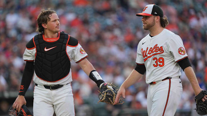 Baltimore Orioles pitcher Corbin Burnes (39) is greeted by catcher Adley Rutschman (35) at the end of the second inning against the Texas Rangers at Oriole Park at Camden Yards on July 27.