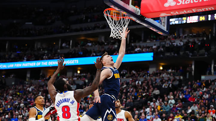 Dec 28, 2024; Denver, Colorado, USA; Denver Nuggets guard Christian Braun (0) shoots the ball past Detroit Pistons forward Tim Hardaway Jr. (8) in the second quarter at Ball Arena. Mandatory Credit: Ron Chenoy-Imagn Images Dec 28, 2024; Denver, Colorado, USA; Denver Nuggets guard Christian Braun (0) shoots the ball past Detroit Pistons forward Tim Hardaway Jr. (8) in the second quarter at Ball Arena. Mandatory Credit: Ron Chenoy-Imagn Images