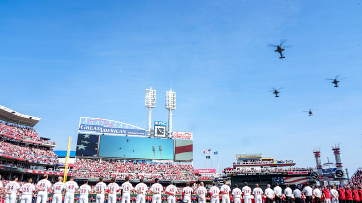Three AH-64 Apache helicopters and one UH-60 Blackhawk helicopter from 1st Battalion, 101st Aviation Regiment, out of Fort Campbell, Kentucky, fly over during the National Anthem before the first inning of the MLB Opening Day game between the Cincinnati Reds and the Boston Red Sox at Great American Ball Park in downtown Cincinnati on Thursday, March 26, 2026. The game was tied at 0 after four innings.
