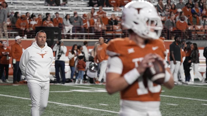 Texas Longhorns head coach Steve Sarkisian observes quarterback Arch Manning (16) warming up before a game, on Nov. 24, 2025 at Darrell K Royal-Texas Memorial Stadium in Austin, Texas.