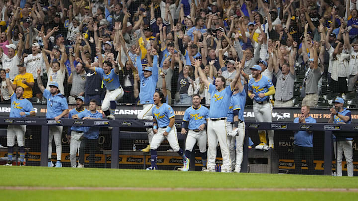 Aug 22, 2025; Milwaukee, Wisconsin, USA; The bench celebrates after a walk off home run in the ninth inning by Milwaukee Brewers catcher William Contreras (24) against the San Francisco Giants at American Family Field. Mandatory Credit: Michael McLoone-Imagn Images