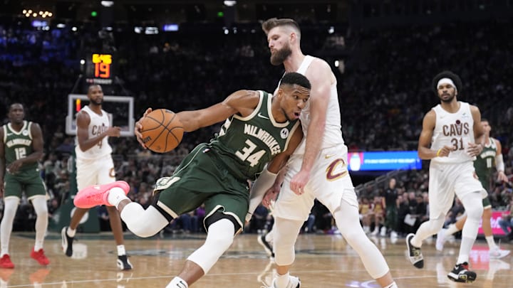 Nov 2, 2024; Milwaukee, Wisconsin, USA; Milwaukee Bucks forward Giannis Antetokounmpo (34) drives against Cleveland Cavaliers forward Dean Wade (32) in the second half at Fiserv Forum. Mandatory Credit: Michael McLoone-Imagn Images