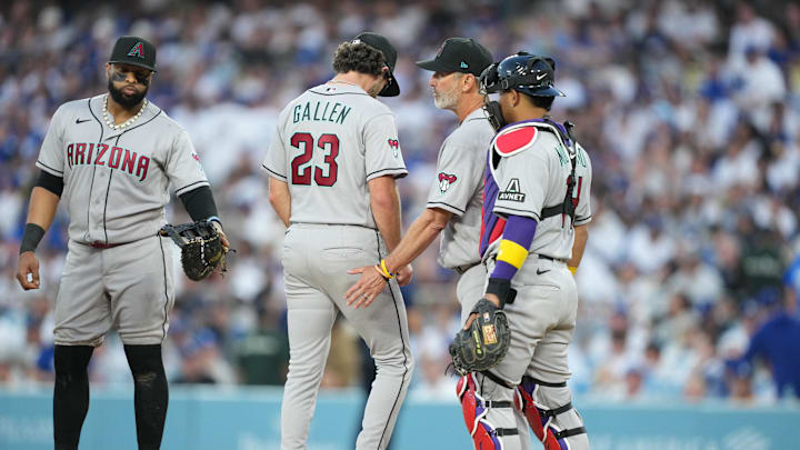 Mar 26, 2026; Los Angeles, California, USA; Arizona Diamondbacks starting pitcher Zac Gallen (23) leaves the mound during a pitching change as manager Torey Lovullo (17), infielder Carlos Santana (41) and catcher Gabriel Moreno (14) look on against the Arizona Diamondbacks during the fifth inning at Dodger Stadium. Mandatory Credit: Kirby Lee-Imagn Images