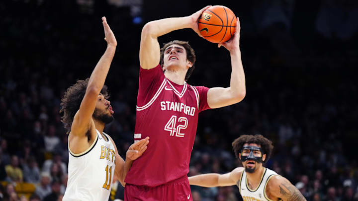 Mar 3, 2024; Boulder, Colorado, USA; Stanford Cardinal forward Maxime Raynaud (42) shoots over Colorado Buffaloes guard Javon Ruffin (11) in the first half at the CU Events Center. Mandatory Credit: Ron Chenoy-Imagn Images