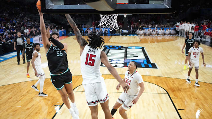 Mar 20, 2025; Wichita, KS, USA; North Carolina-Wilmington Seahawks forward Harlan Obioha (55) shoots against Texas Tech Red Raiders forward JT Toppin (15) in the second half of a first round men’s NCAA Tournament game at Intrust Bank Arena. Mandatory Credit: Kirby Lee-Imagn Images