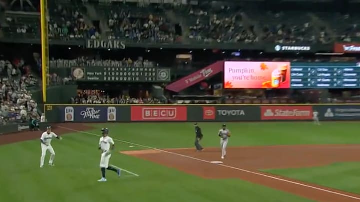 Seattle Mariners centerfielder Julio Rodriguez dodges a flying bat at third base during the bottom of the 10th inning of Wednesday's 2-1 loss to the New York Yankees. 